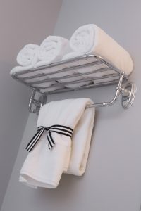 White Towels Hanging From Shelf