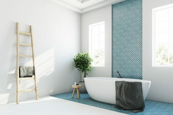White Bathroom with Teal Tile Behind Freestanding Tub